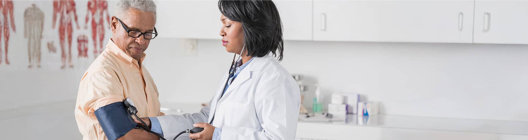 Doctor checking a patient’s blood pressure during an office visit