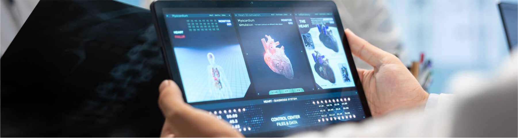 A medical professional views digital heart imaging and diagnostic data on a tablet