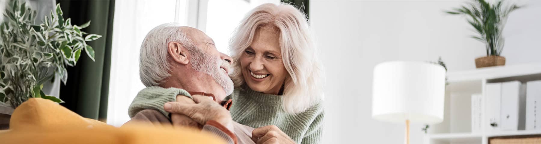 Older couple sharing a smiling moment together at home